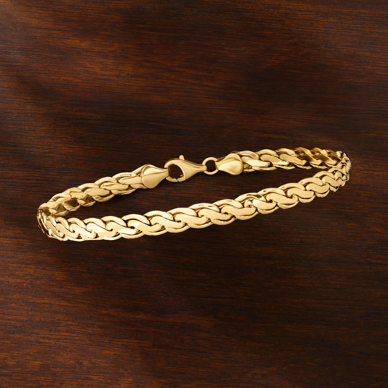 10kt yellow gold curved-link bracelet laid flat, interlocking curb-style links