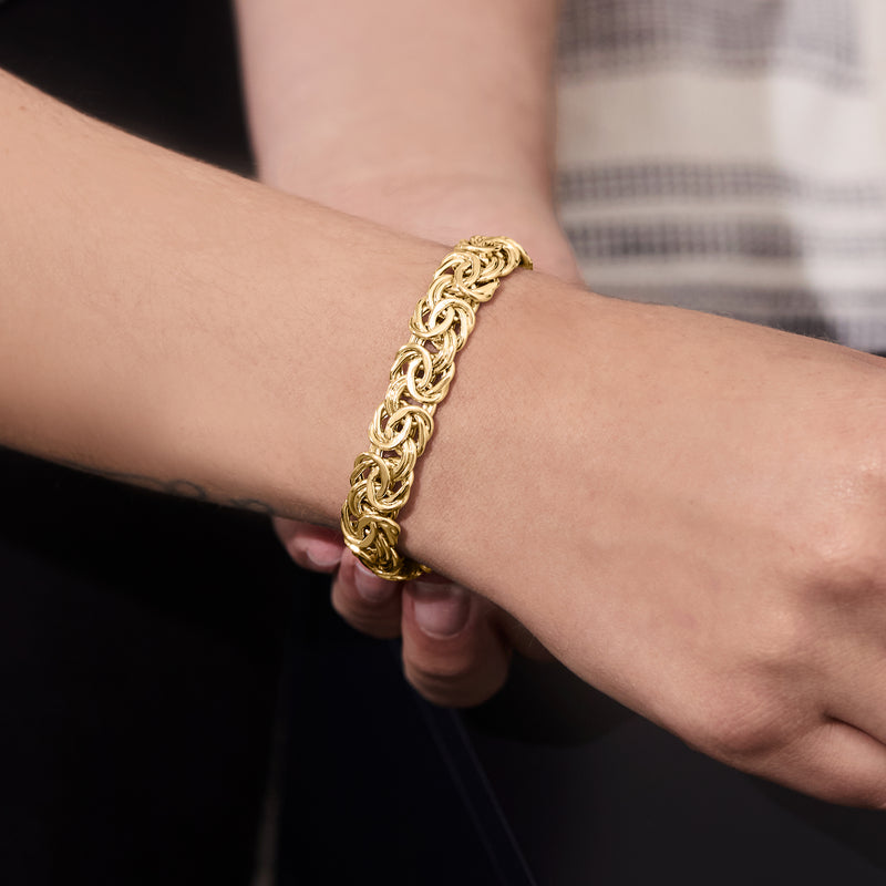 10k yellow gold Byzantine link bracelet on wrist, hinged clasp visible