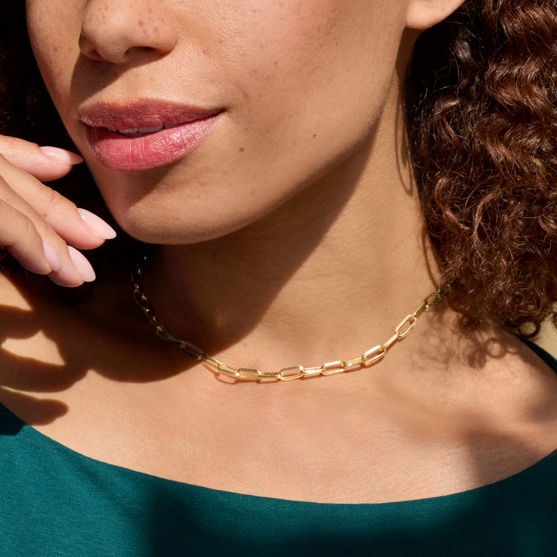 10kt yellow gold paper clip link necklace on skin, rounded rectangular chain links