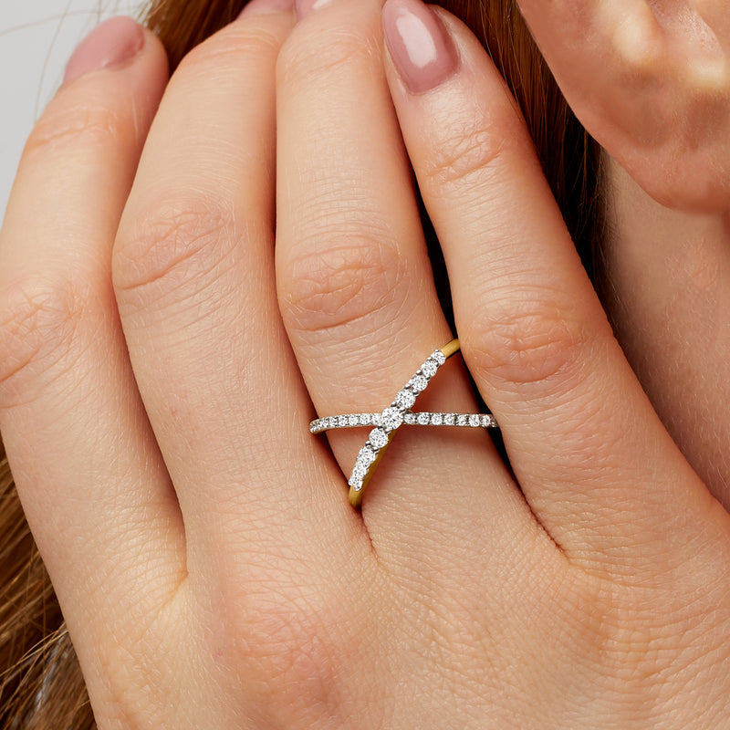 Diamond crisscross ring in 14kt yellow gold on a finger
