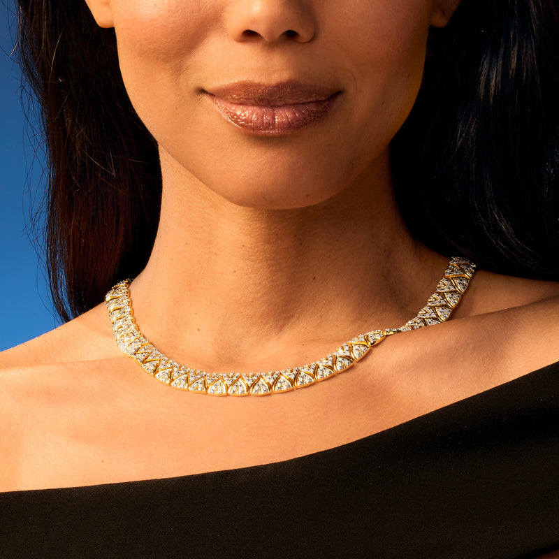 Gold diamond-like collar necklace resting at the collarbone with a sparkling curved row