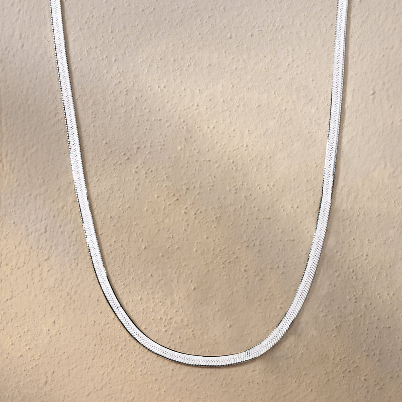 Sterling silver herringbone chain necklace, close-up of curved chain links