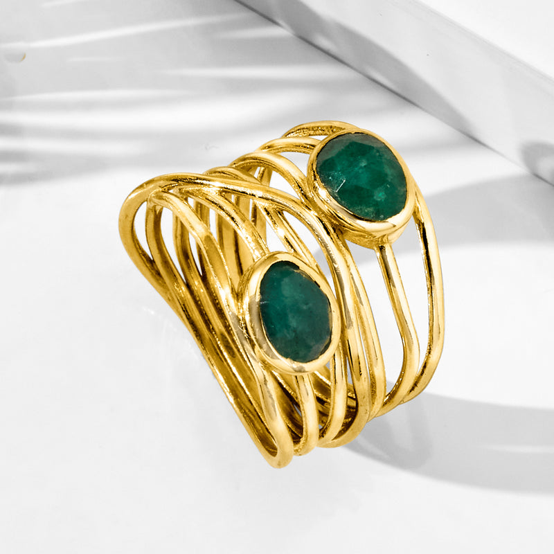 Gold open crisscross ring with two oval green gemstones
