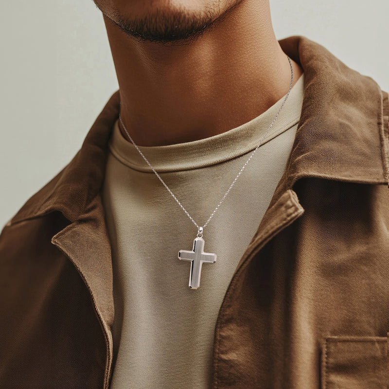 Sterling silver cross pendant on chain, geometric rectangular details at neckline