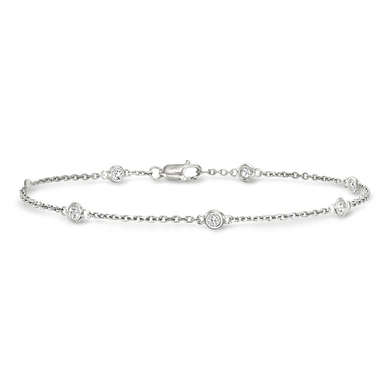 Sterling silver diamond station bracelet with bezel-set round stones and clasp