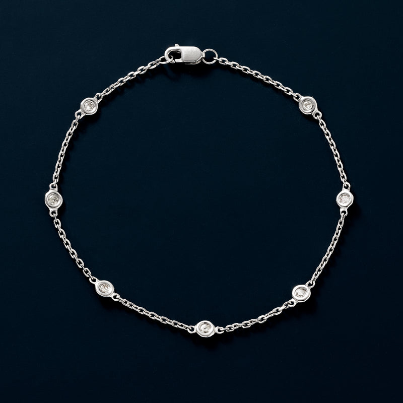Sterling silver diamond station bracelet with round bezel-set stones and link chain