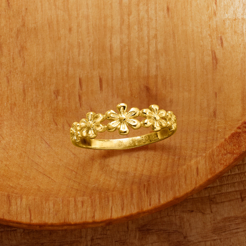 Yellow gold multi-flower ring with clustered floral motifs on the band