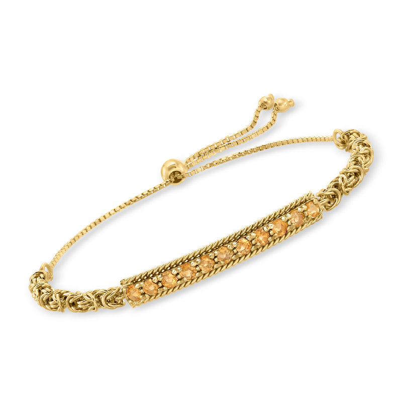 Gold-tone citrine bolo bracelet with braided ends and oval gemstone stations.