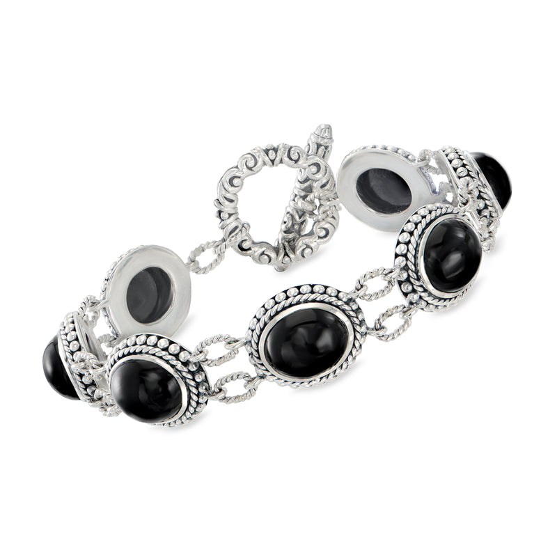 Sterling silver toggle bracelet with ornate links and black oval stone settings