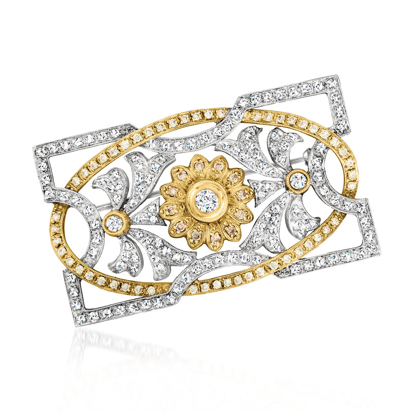 Two-tone gold diamond floral pin with round center yellow gemstone and white stones