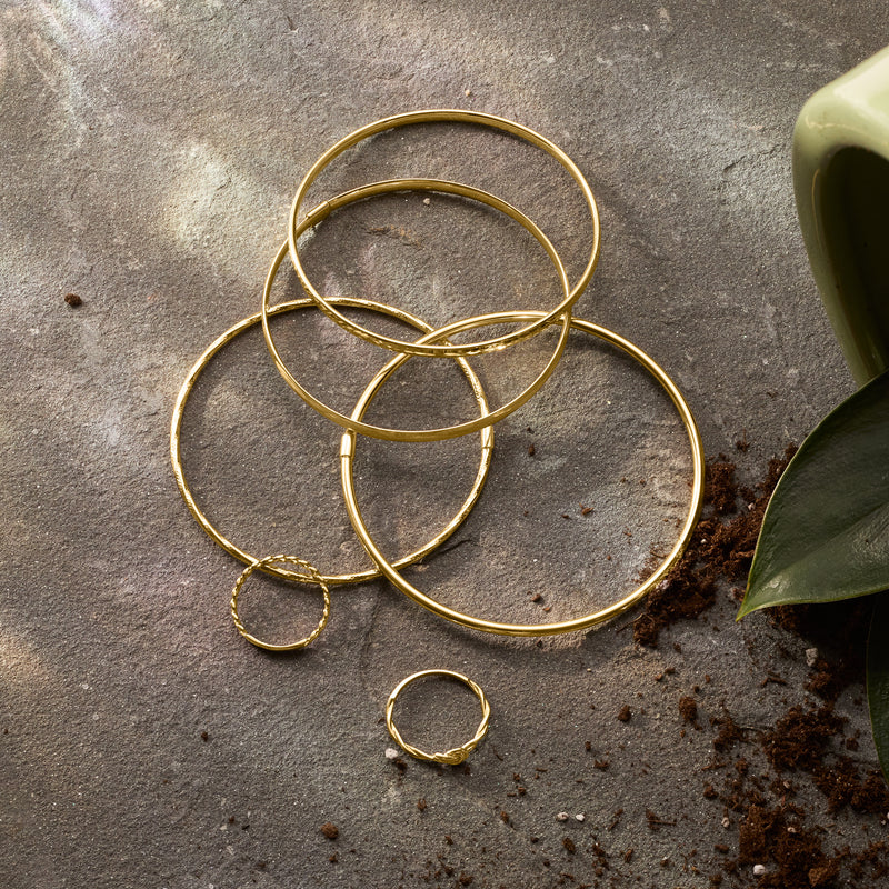 Thin 10kt yellow gold bangle bracelets with small round ring charm