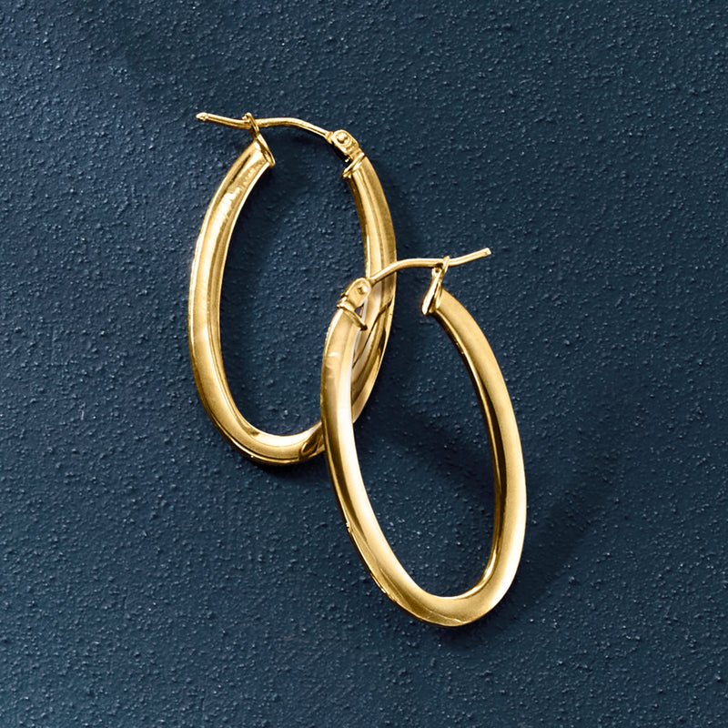 Yellow gold oval hoop earrings, side view showing smooth curved profile