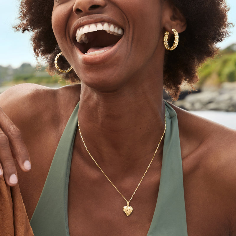 10kt yellow gold heart locket pendant necklace worn at the neckline