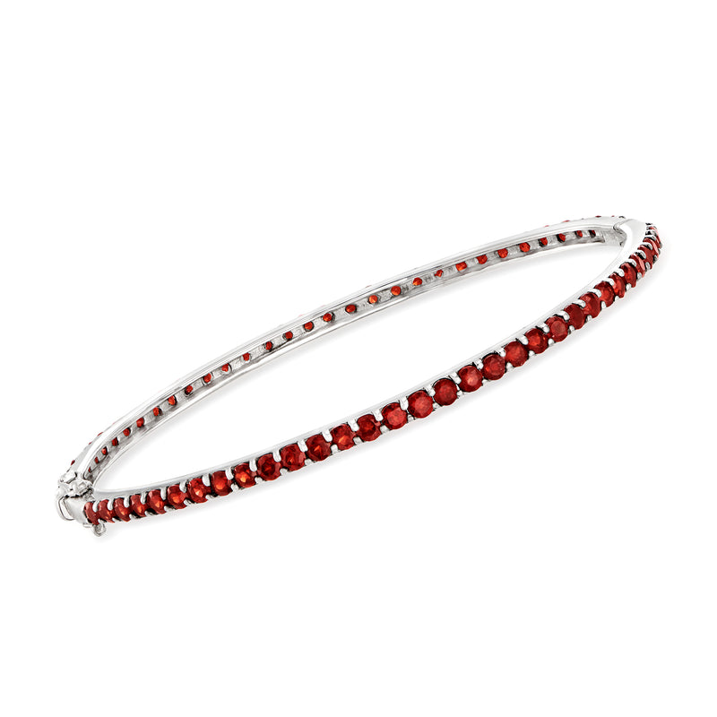 Sterling silver bangle bracelet with red garnet row accents along the band