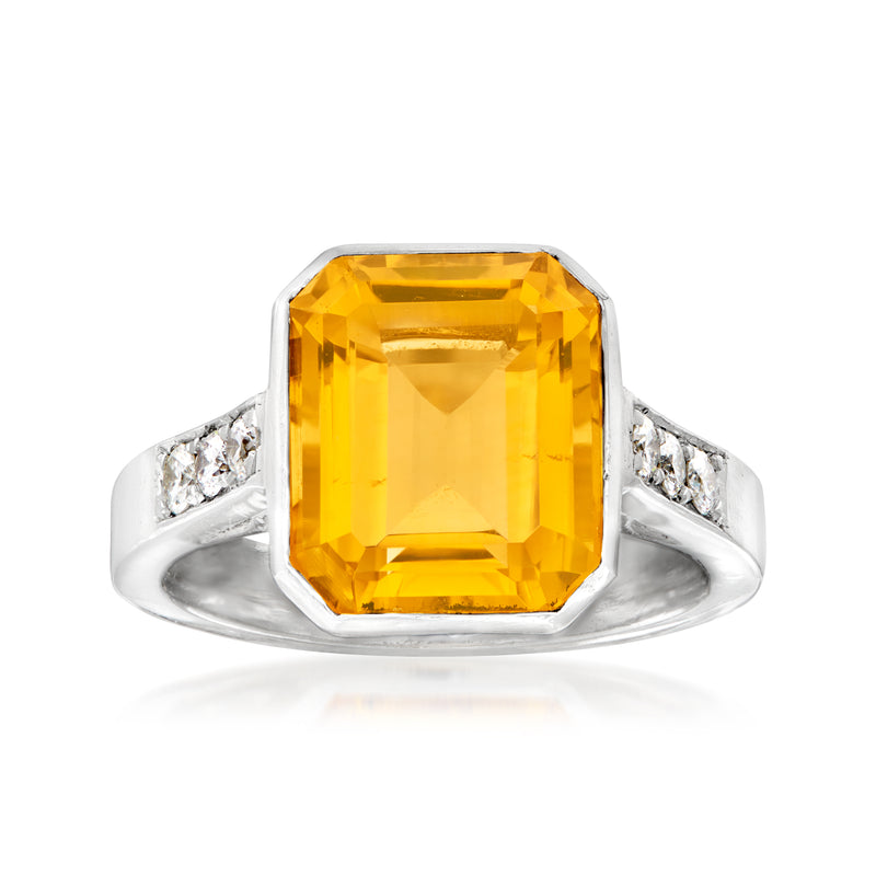 Platinum citrine cocktail ring with large rectangular yellow gemstone and diamond set shoulders