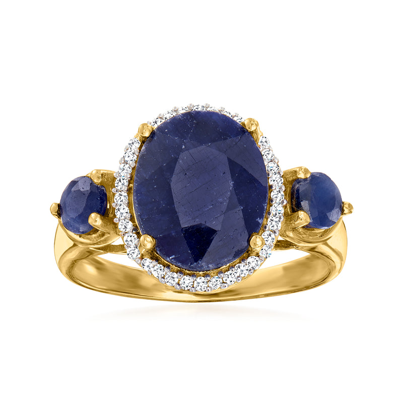 Gold ring with oval blue sapphire center, diamond halo and three side sapphires
