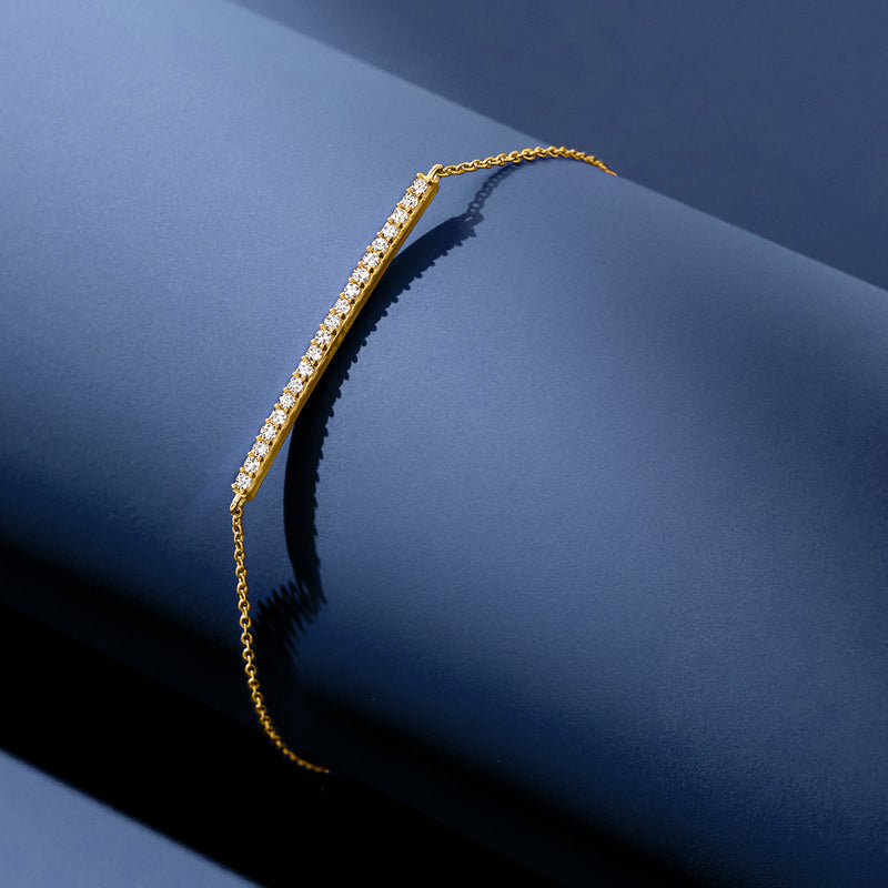 Diamond bar bracelet in 14kt yellow gold with a row of small round diamonds