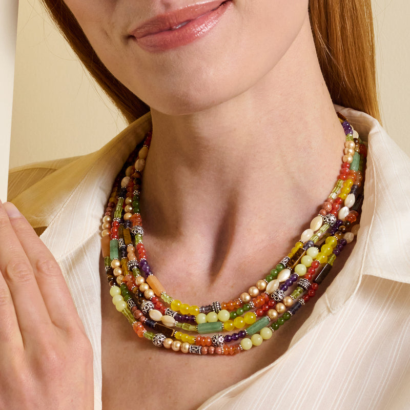 Multi-strand bead necklace on model, colorful gemstones with sterling silver accents.