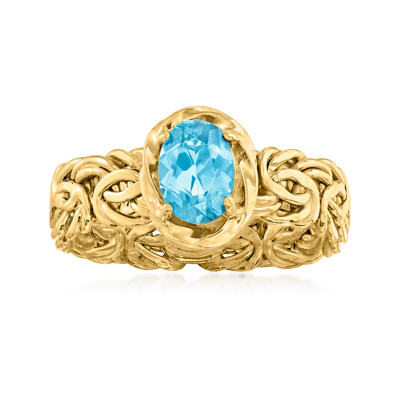 18kt yellow gold ring with oval Swiss blue topaz center and Byzantine braided band