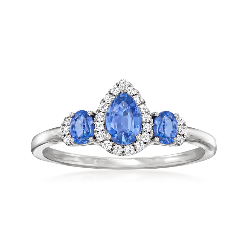 Blue sapphire ring with oval center stone, diamond halo, three side sapphires