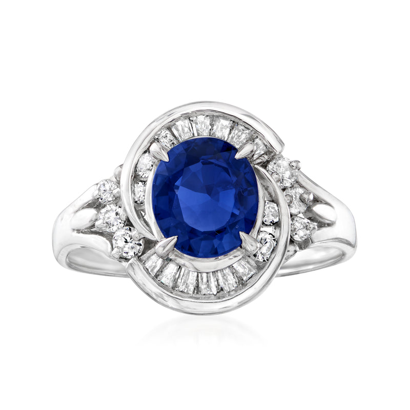 Vintage platinum ring with oval blue sapphire center and diamond halo swirl shoulders