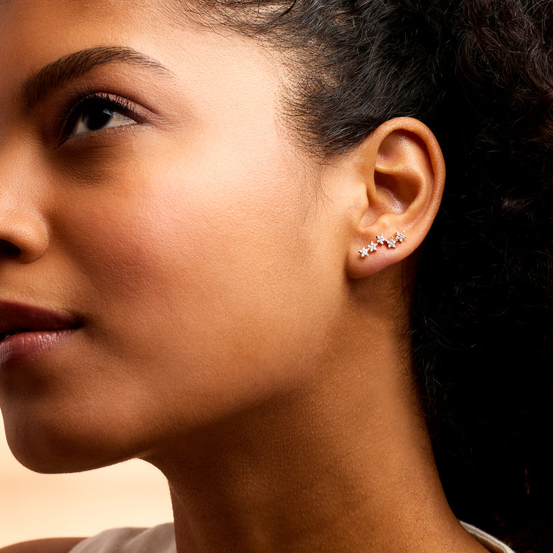 Diamond star ear climber earrings on model ear, 14kt yellow gold