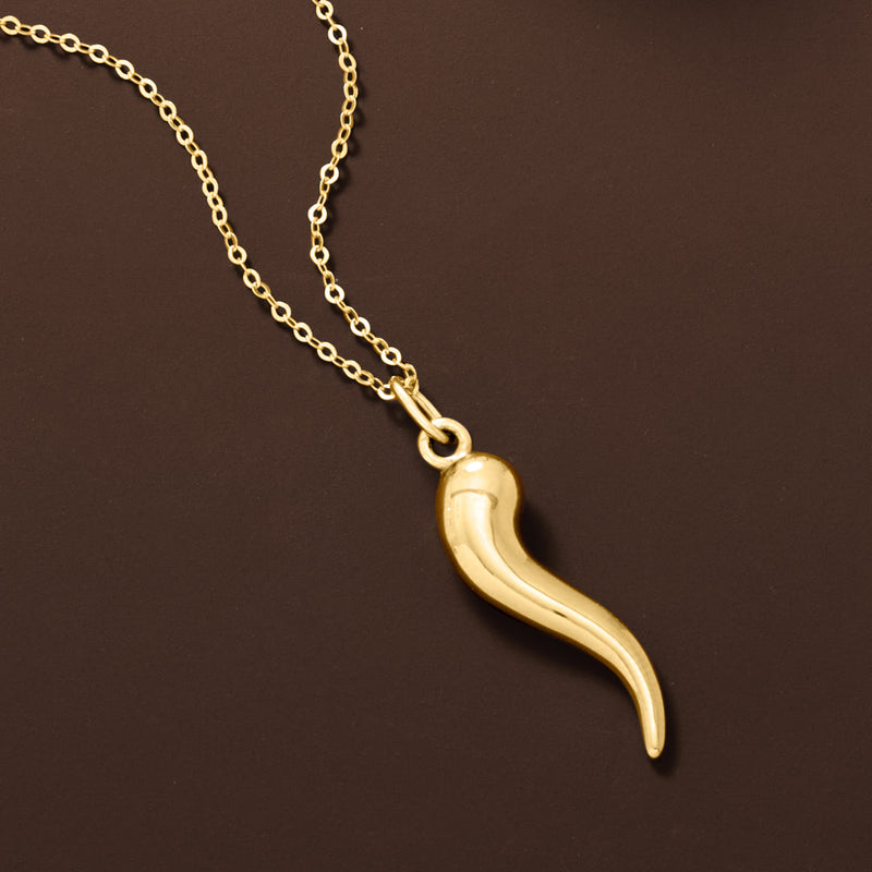 Curved gold horn pendant necklace on linked chain with rounded bail at top.