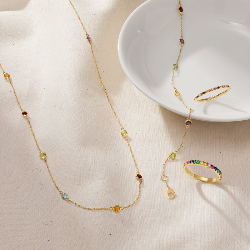 14kt yellow gold station bracelet with small round multicolor gemstones on a delicate chain
