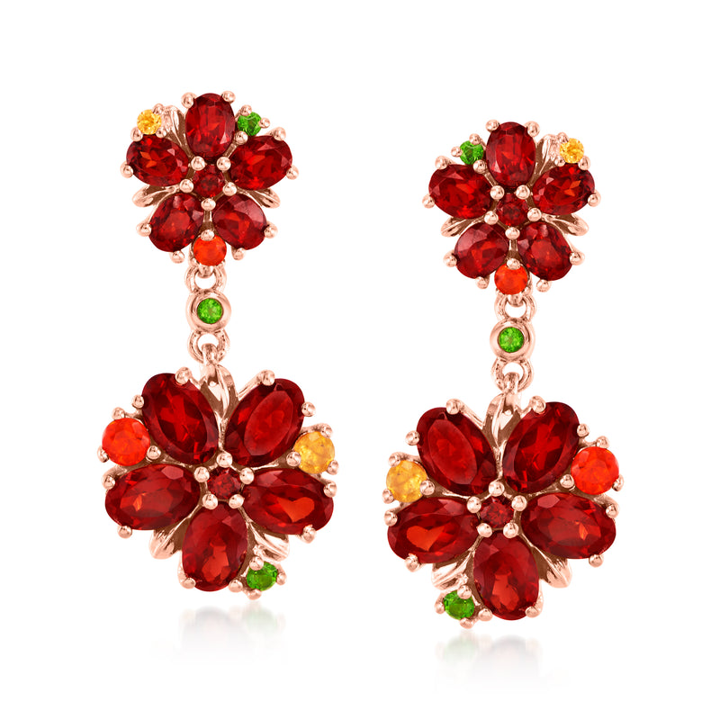 Rose gold flower drop earrings with red gemstone petals and small green accents