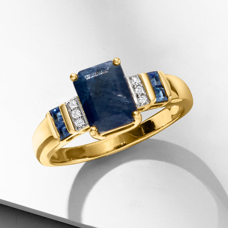 Yellow gold ring with rectangular sapphire, diamond set sides, and blue stones