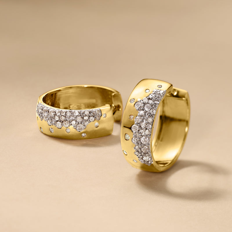 Gold hoop earrings with clustered diamond stones along the front half