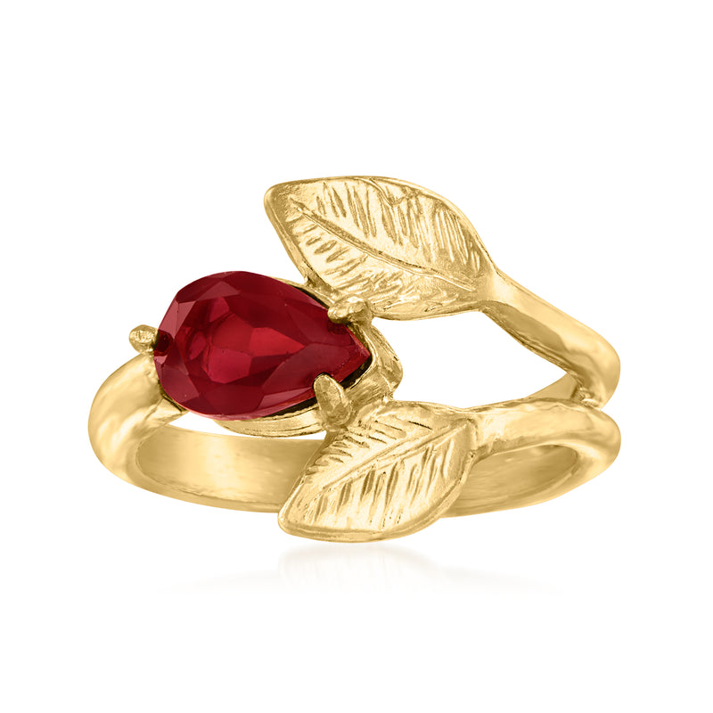 Gold-tone leaf ring with oval deep red garnet-style gemstone and open band