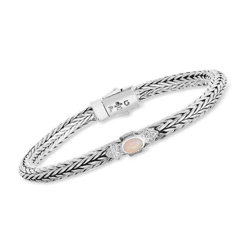 Sterling silver woven bracelet with oval opal centerpiece and white sapphire accents
