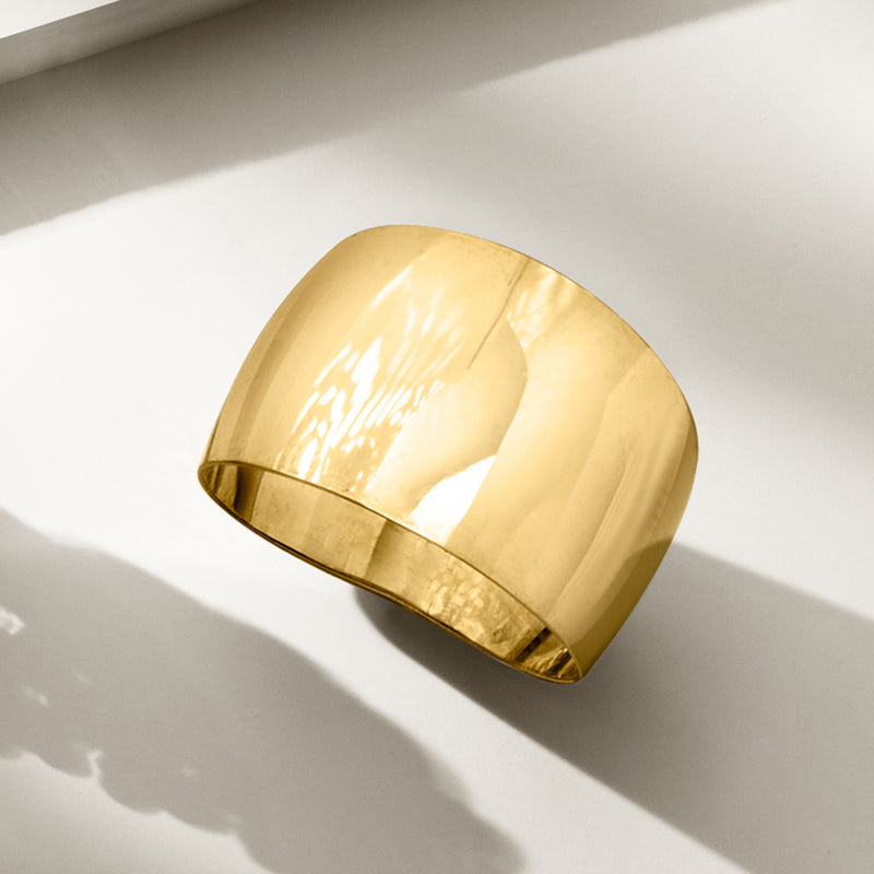 Wide dome 14kt yellow gold ring, side view showing tapered band