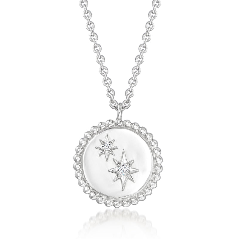 Sterling silver star necklace with round diamond-inlaid pendant and three star accents