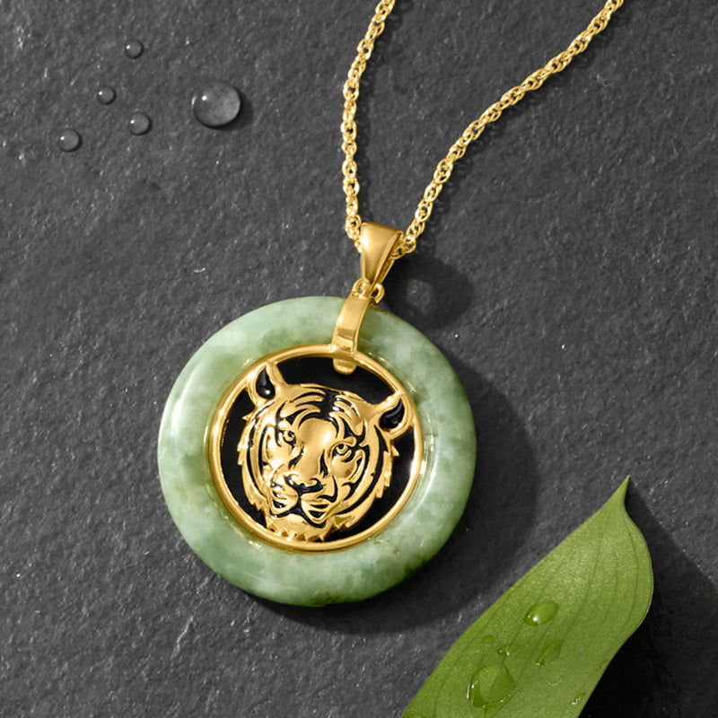 Round green jade pendant with raised tiger head in gold frame on chain