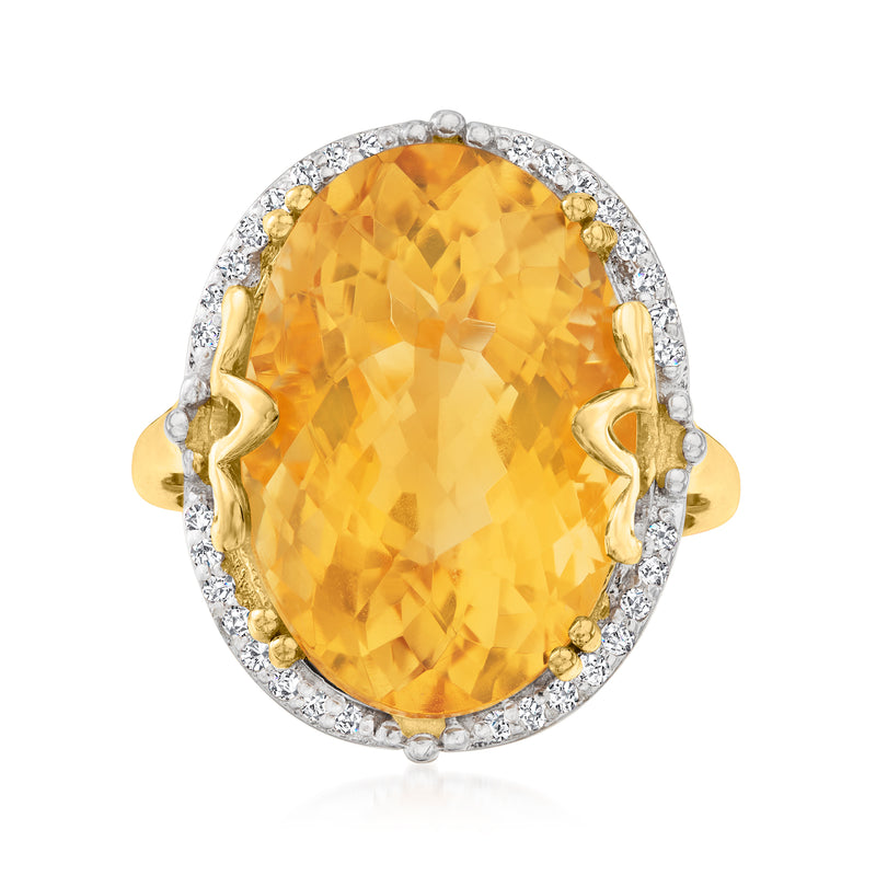 Oval citrine ring with diamond halo, gold prongs, and split shoulders