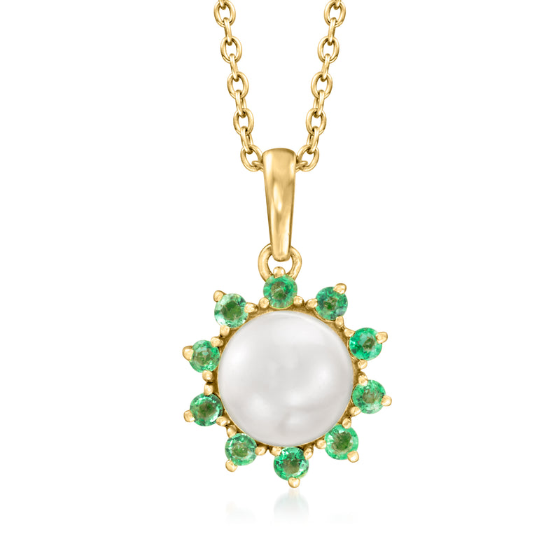 Gold pendant necklace with white pearl center and green gemstone flower setting