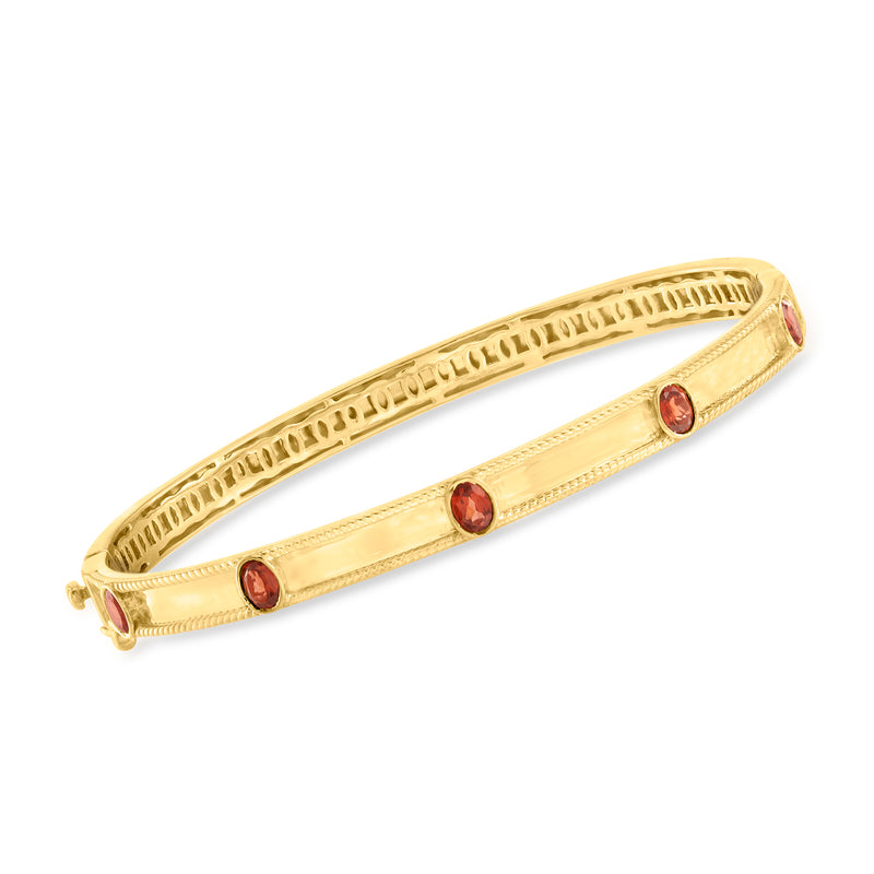 18kt gold over sterling garnet station bangle with three red gemstone accents