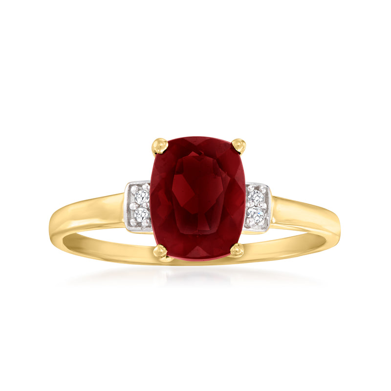 10kt yellow gold ring with oval red garnet center and white topaz side accents