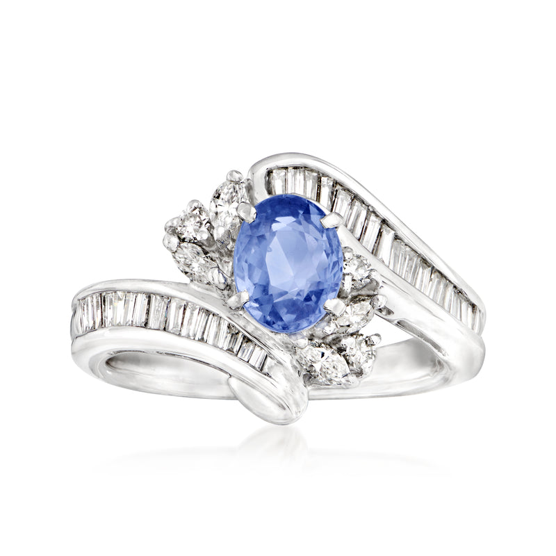 Platinum ring with oval blue sapphire center, baguette diamonds and round diamond cluster