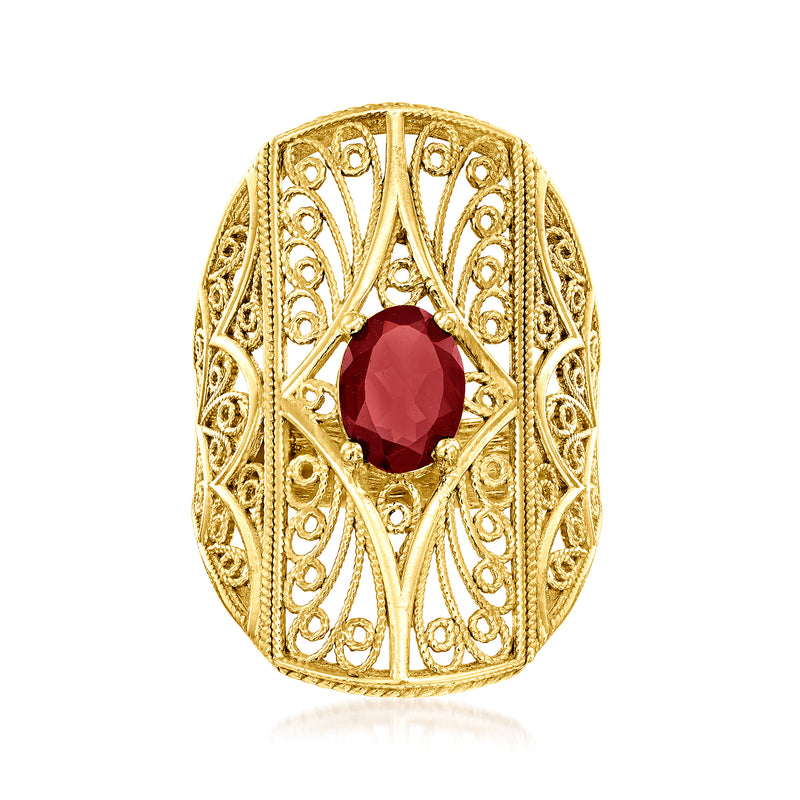 Gold-tone filigree ring with oval red garnet centerpiece and openwork halo