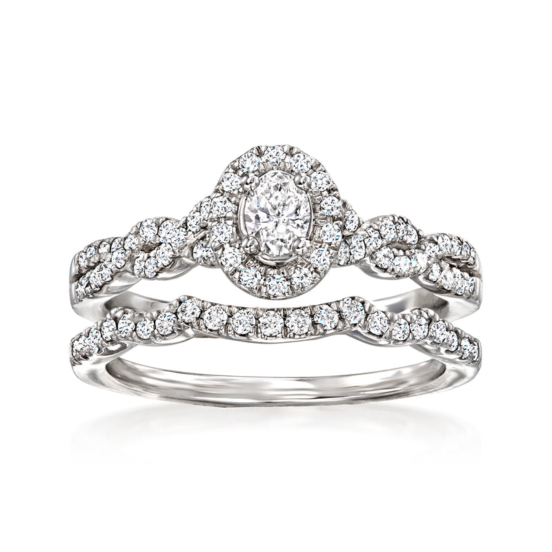 Diamond bridal set in 14kt white gold with oval halo engagement ring and matching band