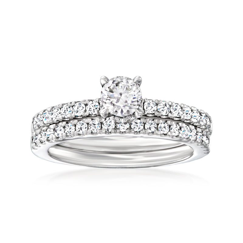 Diamond bridal set in 14kt white gold with round center stone and pavé bands