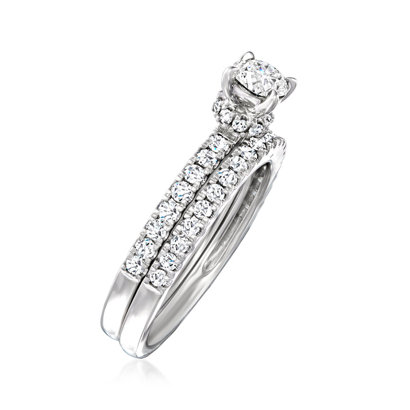 Diamond bridal set in 14kt white gold with halo engagement ring and band