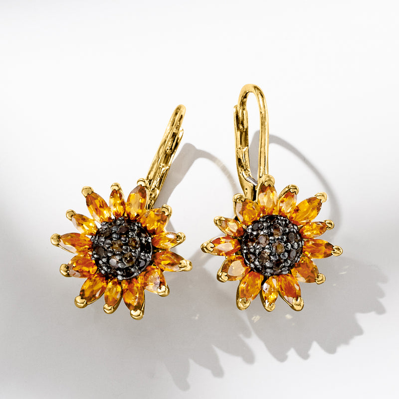 Gold sunflower drop earrings on dark pave centers with orange gemstone petals, leverback