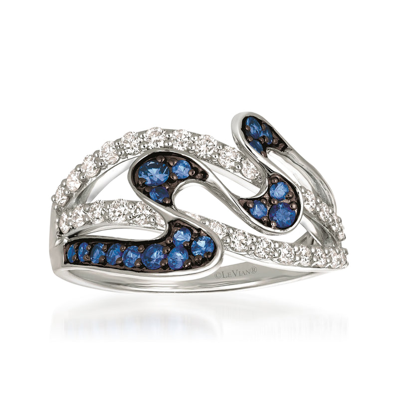 Swirl ring with blue sapphire-like clusters and white diamond accents on a metallic band