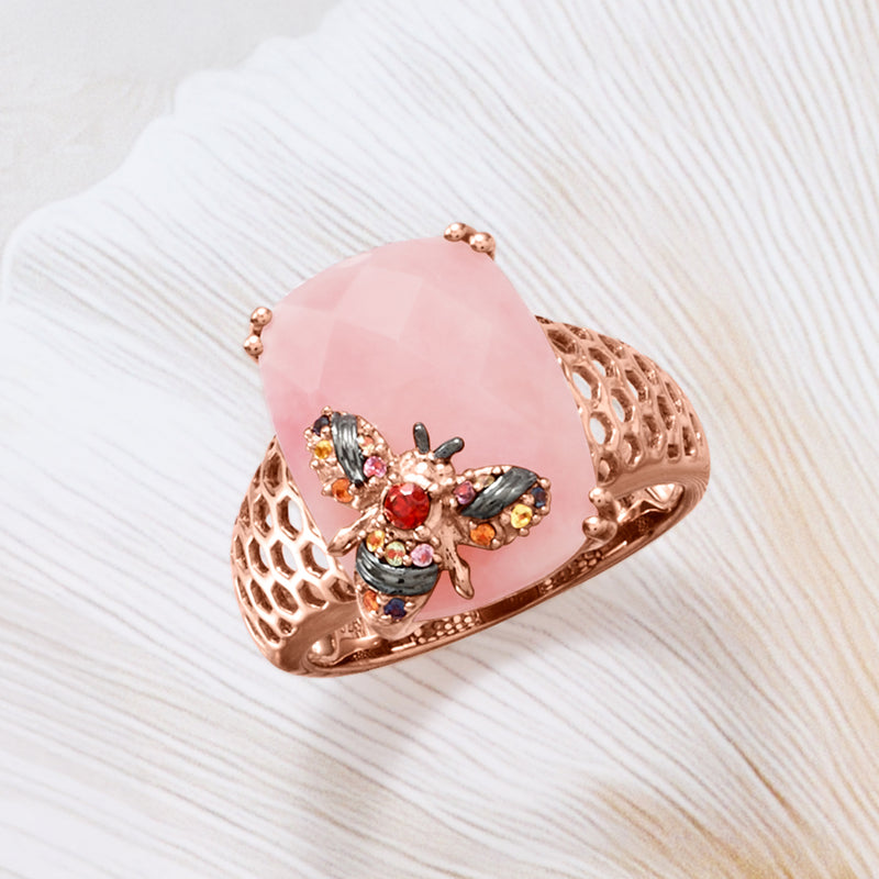 Rose gold-tone filigree ring with pink oval center and multicolor gemstone bee design