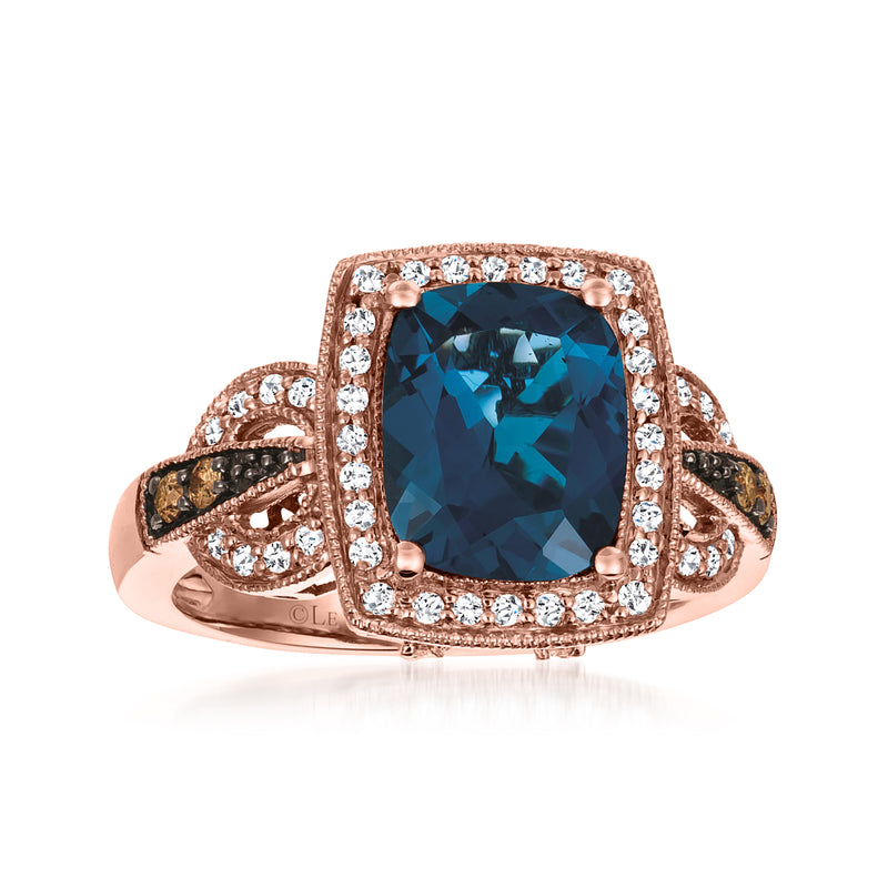 Rose gold ring with cushion-cut deep blue topaz and diamond halo and accents