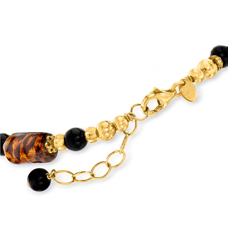 Gold-tone bracelet clasp with black beads and amber speckled oval glass beads